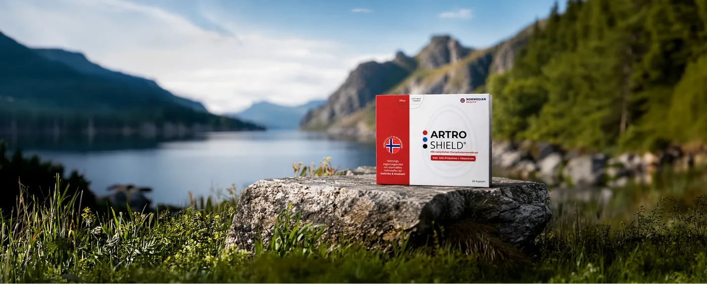 ArtroShield-Packung auf einem Felsen vor norwegischer Fjordlandschaft